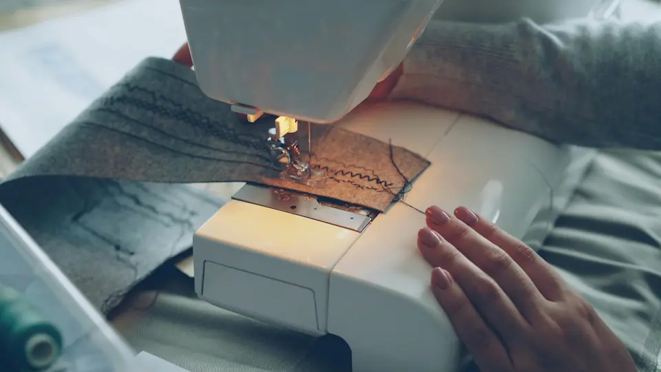 Hands crafting a bag